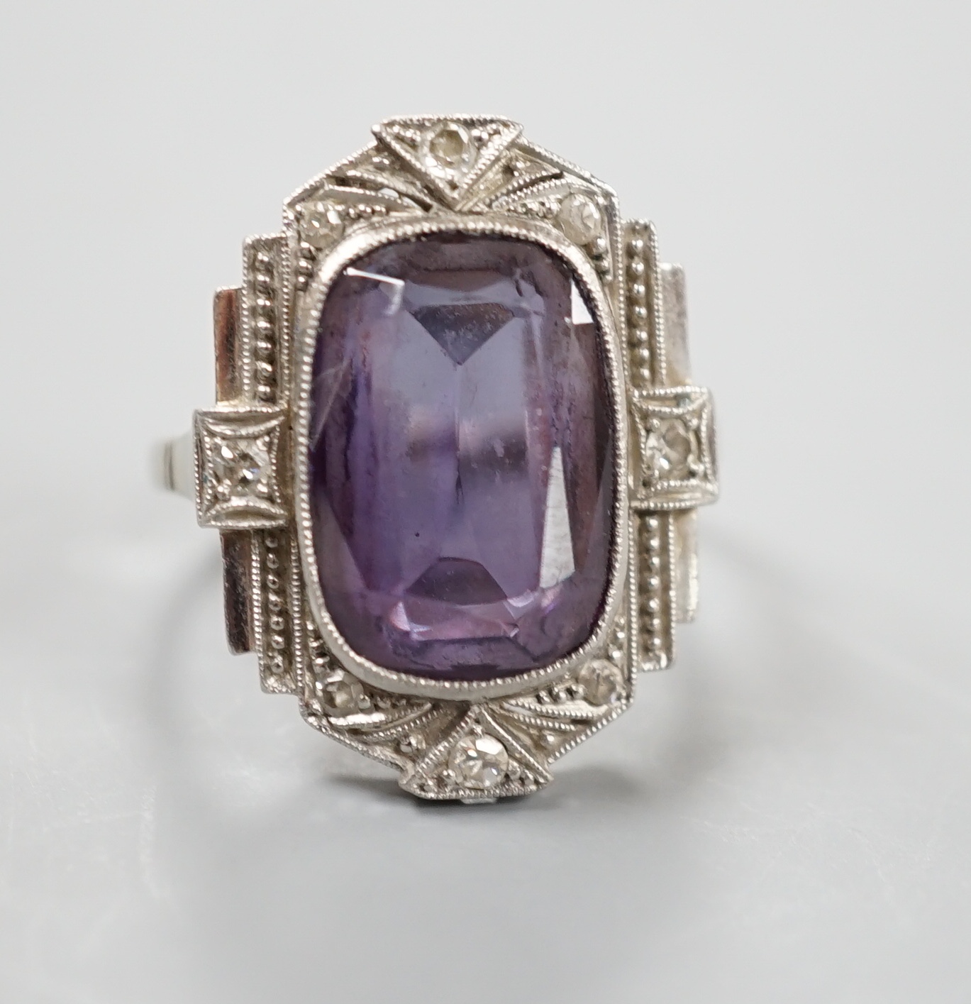 An Art Deco style white metal, synthetic colour change corundum and diamond chip set dress ring, size L/M, gross weight 5.6 grams.